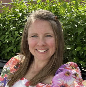 Bethany-Lightfield Professional woman smiling outdoors in natural greenery for corporate and business branding.