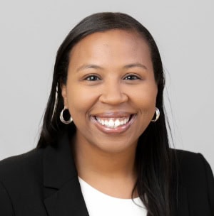 Ashley-Walker Professional woman smiling in business attire, representing CTLG Consulting services.