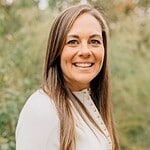 Professional woman smiling outdoors, representing CTLG consulting services for business growth.