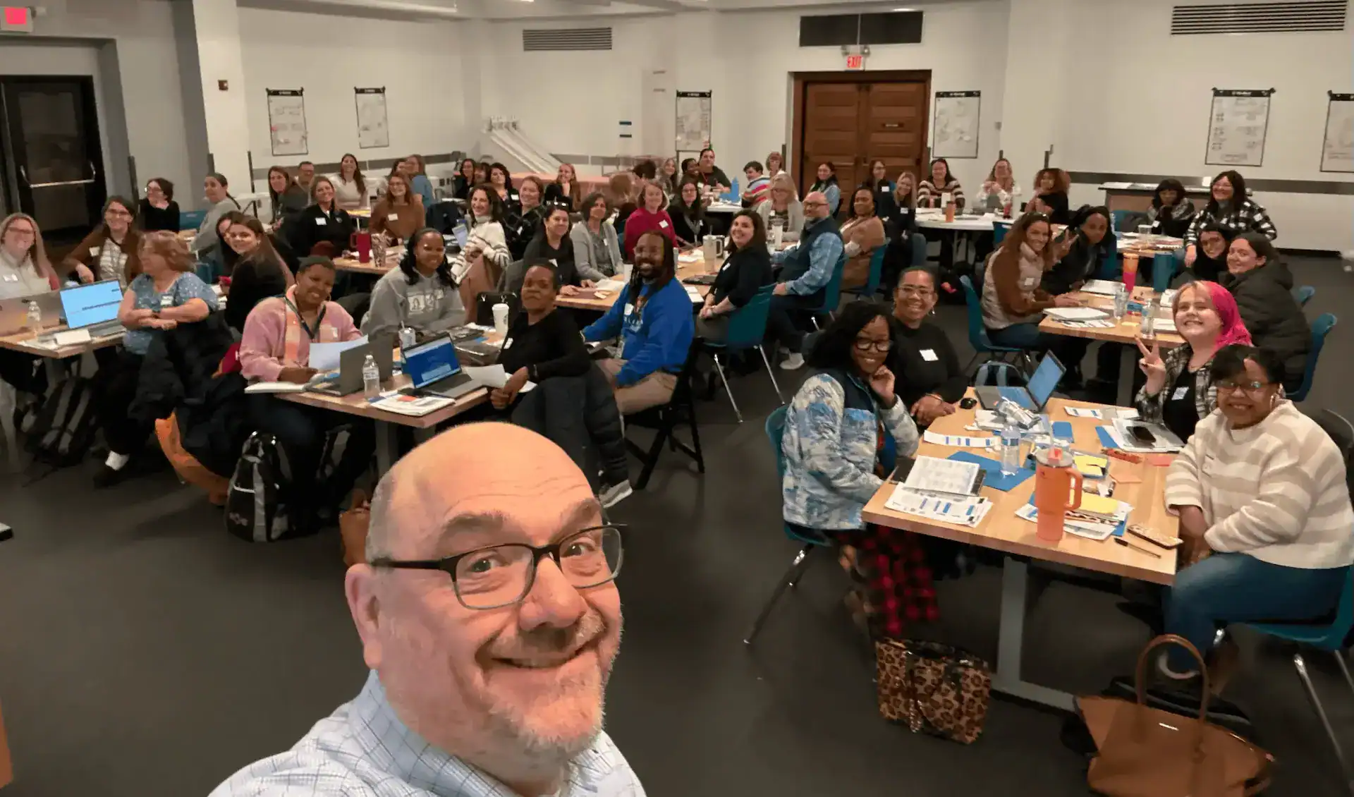 Group of diverse professionals attending a CTLG consulting workshop in a conference room.